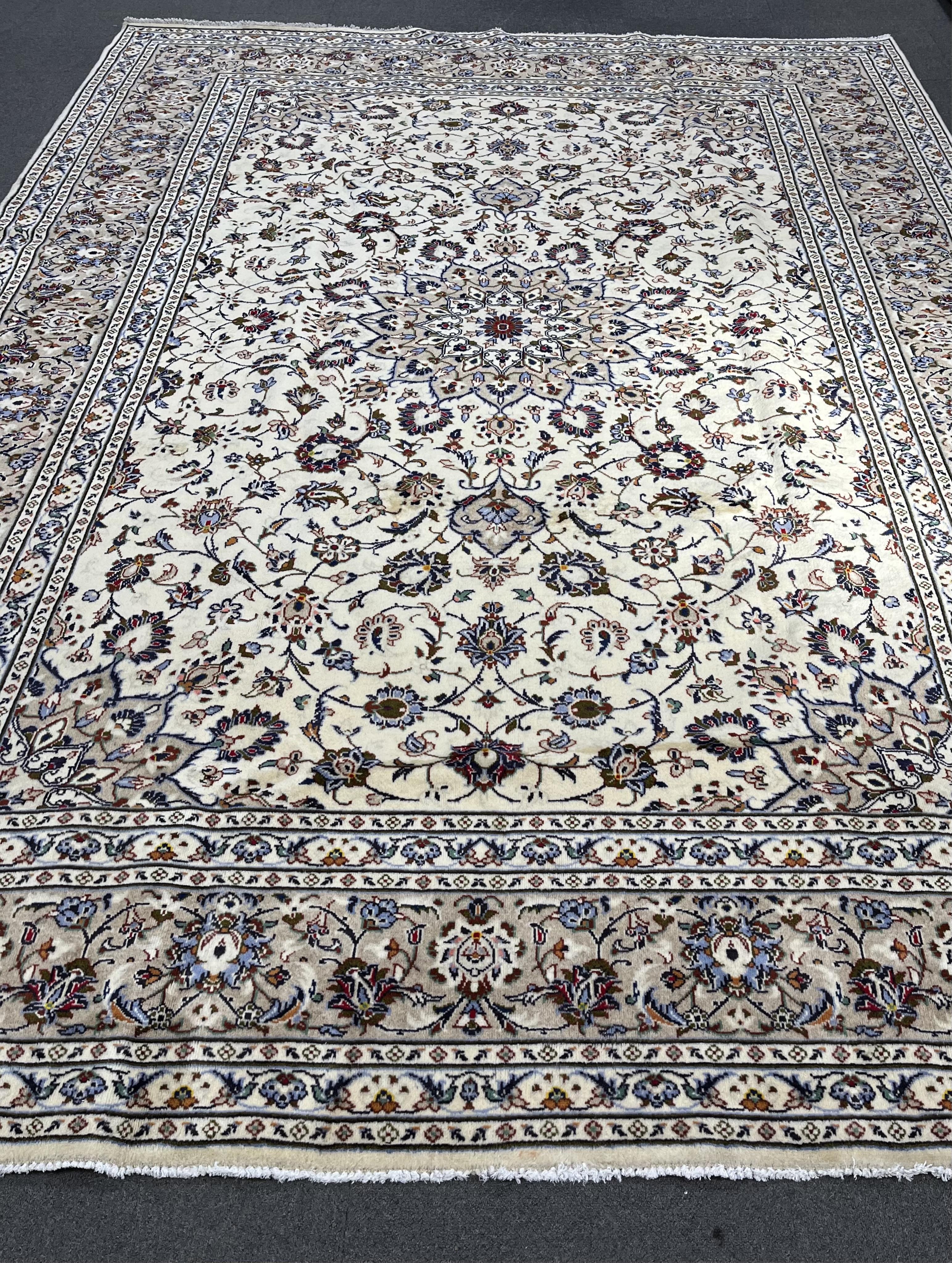 A Kashan ivory ground carpet, 346 x 245. Condition - good